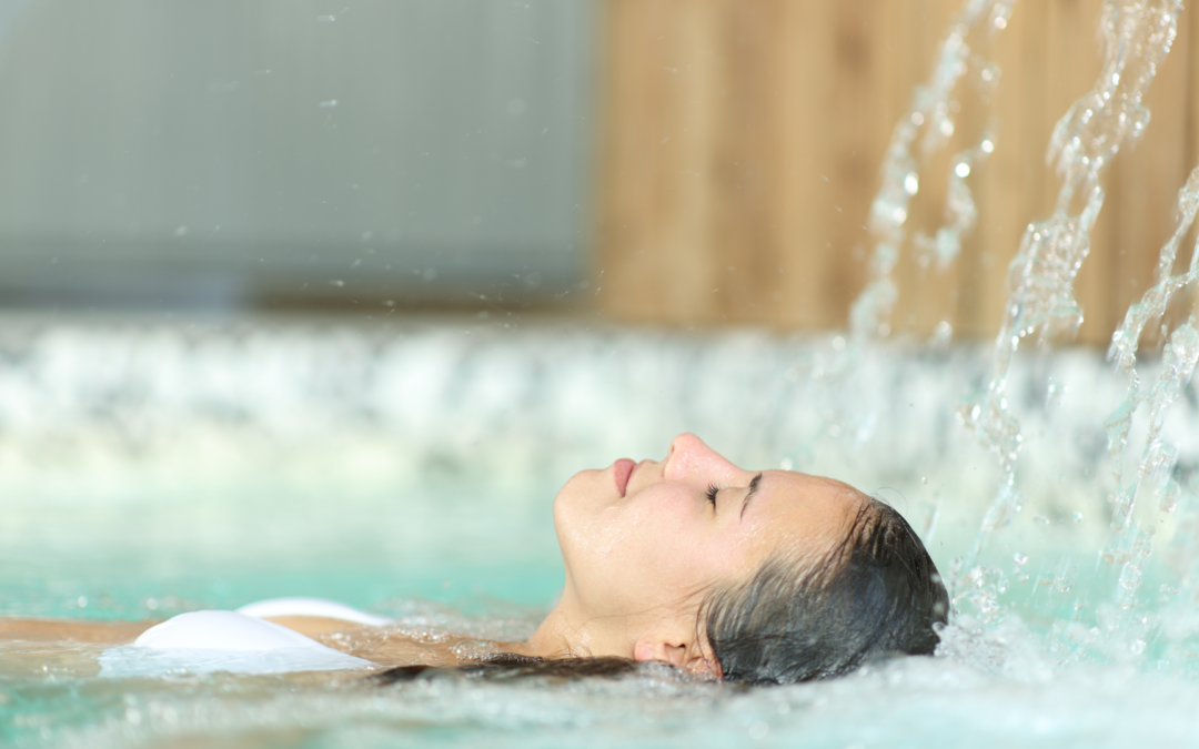 a woman lying in a pool with water pouring out of her head